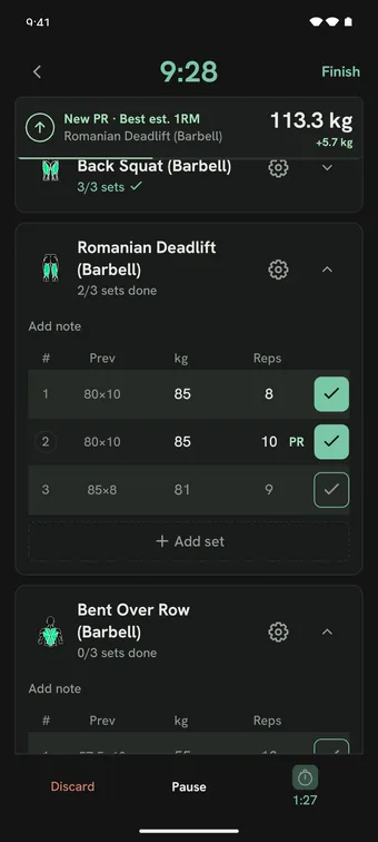 An active workout: a New PR notice for Romanian Deadlift (Barbell) at the top, each set with its previous numbers, the second set marked PR, and the Discard, Pause, and rest timer bar.